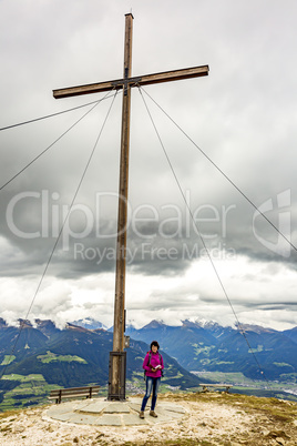 Woman with summit cross on the Astjoch in South Tyrol