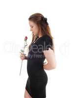 Woman in black dress holding a red rose