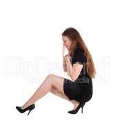 Pretty young woman crouching on the floor