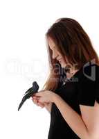 Woman holding a fake bird in her hands