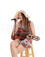 Woman playing the guitar and singing