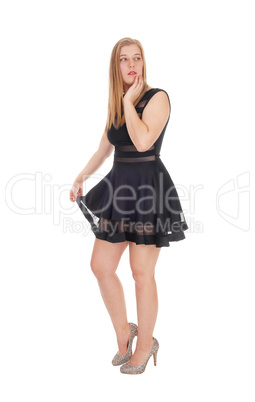 Happy woman standing in a short black dress