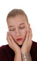 Sad looking woman with hand on face