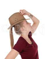 Woman posing with brown cowboy hat