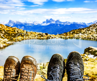 Hiking boots in the mountains in front of a lake