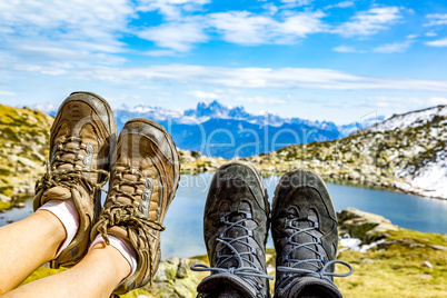 Hiking boots in the mountains in front of a lake