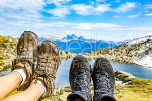 Hiking boots in the mountains in front of a lake