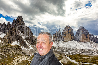 Man in front of the Three Peaks in the Dolomites Italy