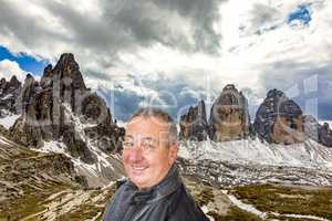Man in front of the Three Peaks in the Dolomites Italy