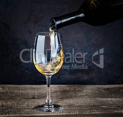 Pouring white wine from bottle