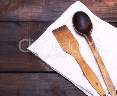 wooden spoon and kitchen spatula on a textile towel