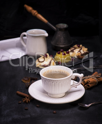 white ceramic cup with black coffee