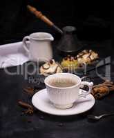 white ceramic cup with black coffee