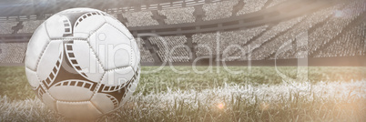 Composite image of soccer ball on white marking line