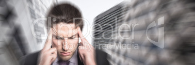 Composite image of tensed businessman suffering from headache