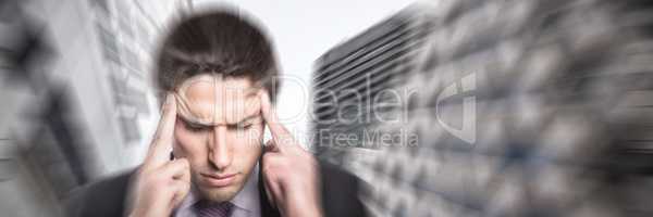 Composite image of tensed businessman suffering from headache