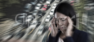 Composite image of businesswoman suffering from headache