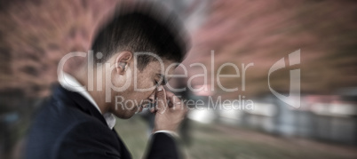 Composite image of side view of businessman with head in hand suffering from headache