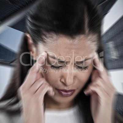 Composite image of businesswoman having an headache