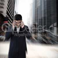 Composite image of businessman with head in hand suffering from headache