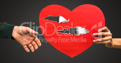 Couple holding hurt love heart with torn paper