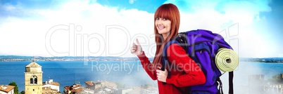 Travelling woman with bag in front of holiday landscape