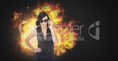 Cool sexy woman in sunglasses with burning fire flames