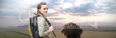 Travelling woman with bag in front of landscape