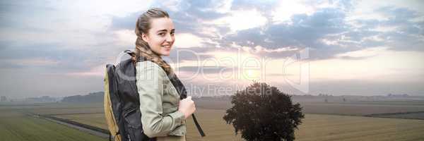 Travelling woman with bag in front of landscape