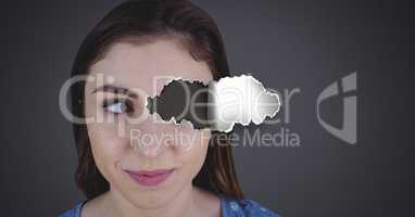 Woman with torn paper on eye
