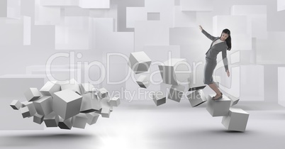 Woman balancing on geometric surreal cubes