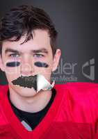 American football player with torn paper on mouth