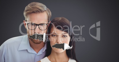 Couple with torn paper on mouths