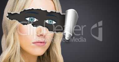 Woman with torn paper on eyes and drawn eyes