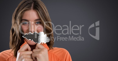 Woman with torn paper on mouth