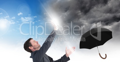 Man blocking Grey sky and blue sky weather change surreal transition and umbrella