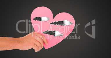 Hand holding hurt love heart with torn paper