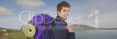 Travelling man with bag in front of landscape