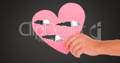 Hand holding hurt love heart with torn paper