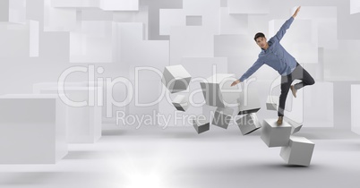 Man balancing on geometric surreal cubes