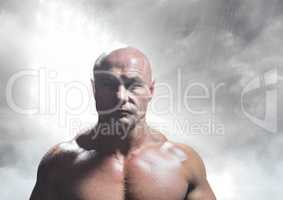 Strong bald man in grey light