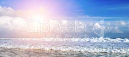 Beautiful seascape and sun on blue sky background. Extensive san