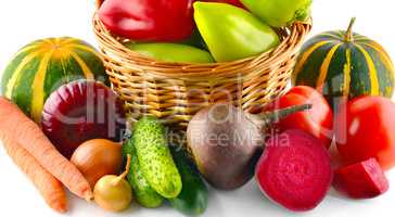 Set of vegetables in wicker basket isolated on white.