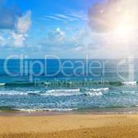 Beautiful seascape and sun on blue sky background. Extensive san