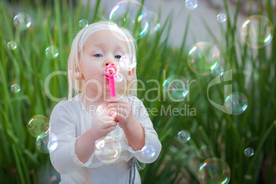 Adorable Little Girl Sitting On Bench Having Fun With Blowing Bu Adorable Little Girl Sitting On Bench Having Fun With Blowing Bu