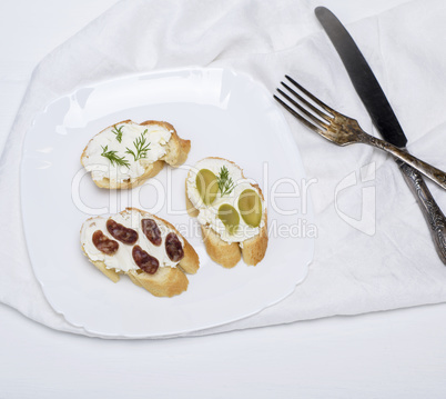 sandwiches with cream cheese on a white plate