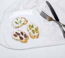 sandwiches with cream cheese on a white plate