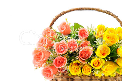 Silk red and yellow roses in a basket isolated on white backgrou