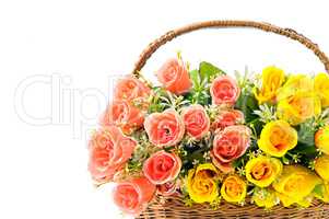 Silk red and yellow roses in a basket isolated on white backgrou