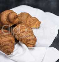 fresh baked croissants on a white textile napkin